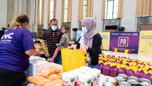 Volunteers packing food boxes for Project Ramadan initiative to support families in need during the holy month.