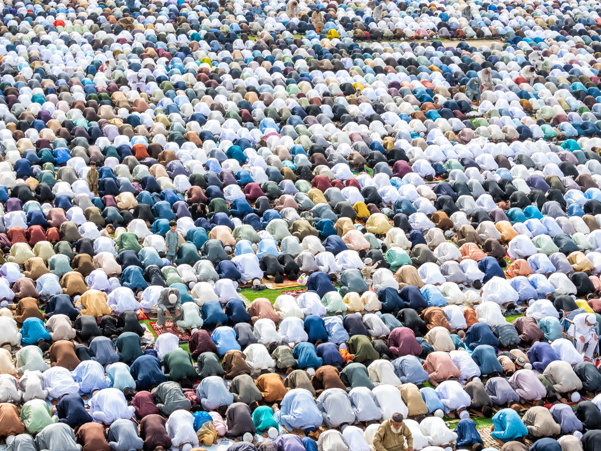 A sea of Muslim worshippers in prostration (Sajdah)